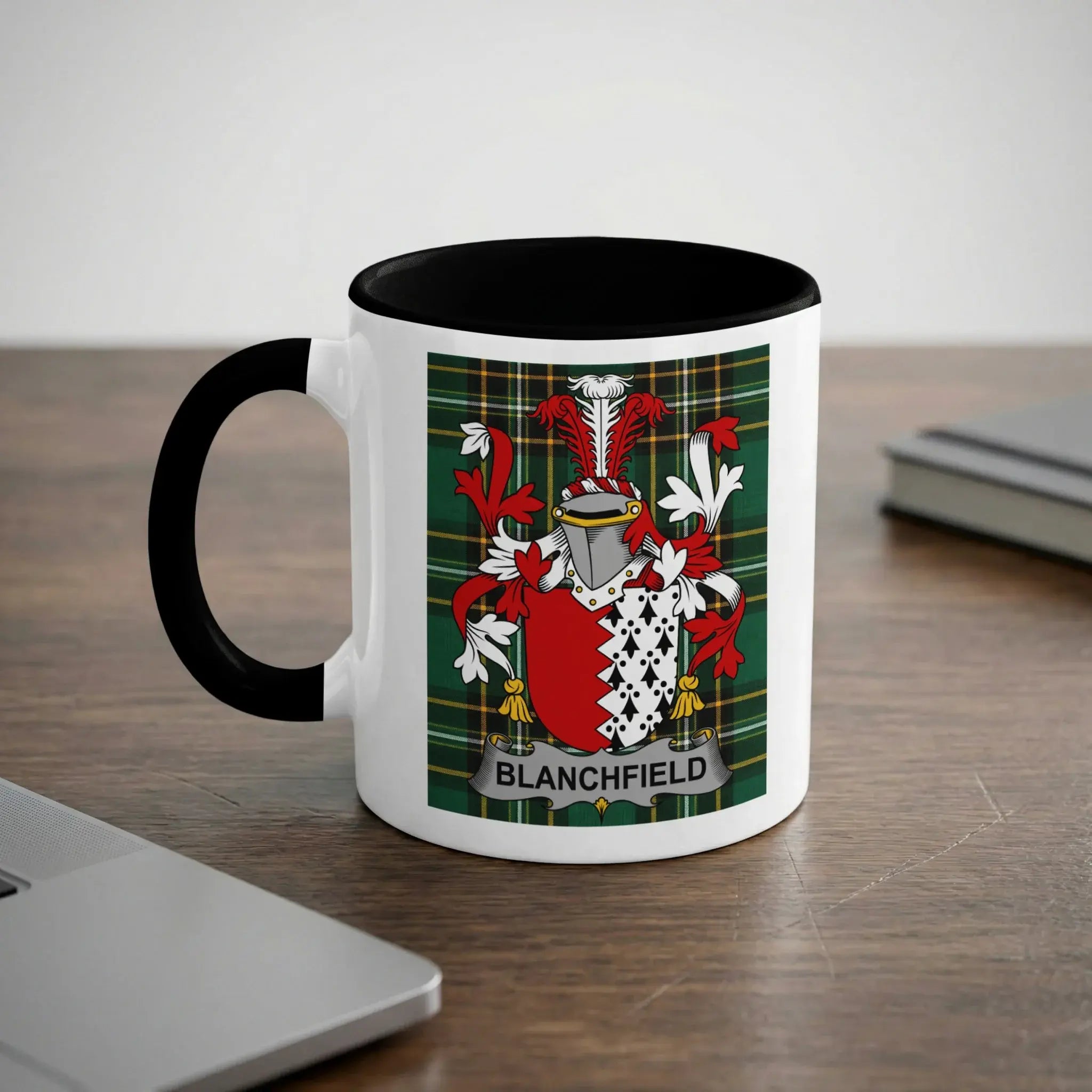 White mug with black rim featuring the Blanchard family crest on a tartan background.