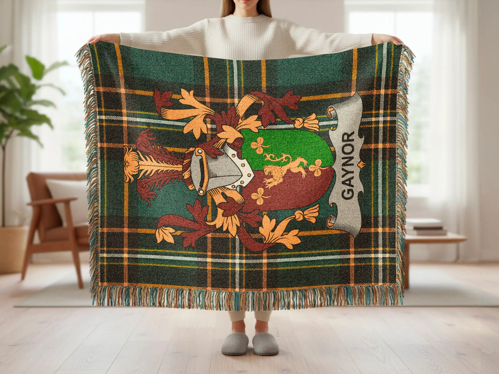 Green plaid throw blanket featuring a crest with "GAYNOR" text.