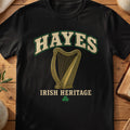 Hayes Irish harp T-shirt in Black, with cream surname lettering, a gold-toned harp, green shamrock and “Irish Heritage” text.
