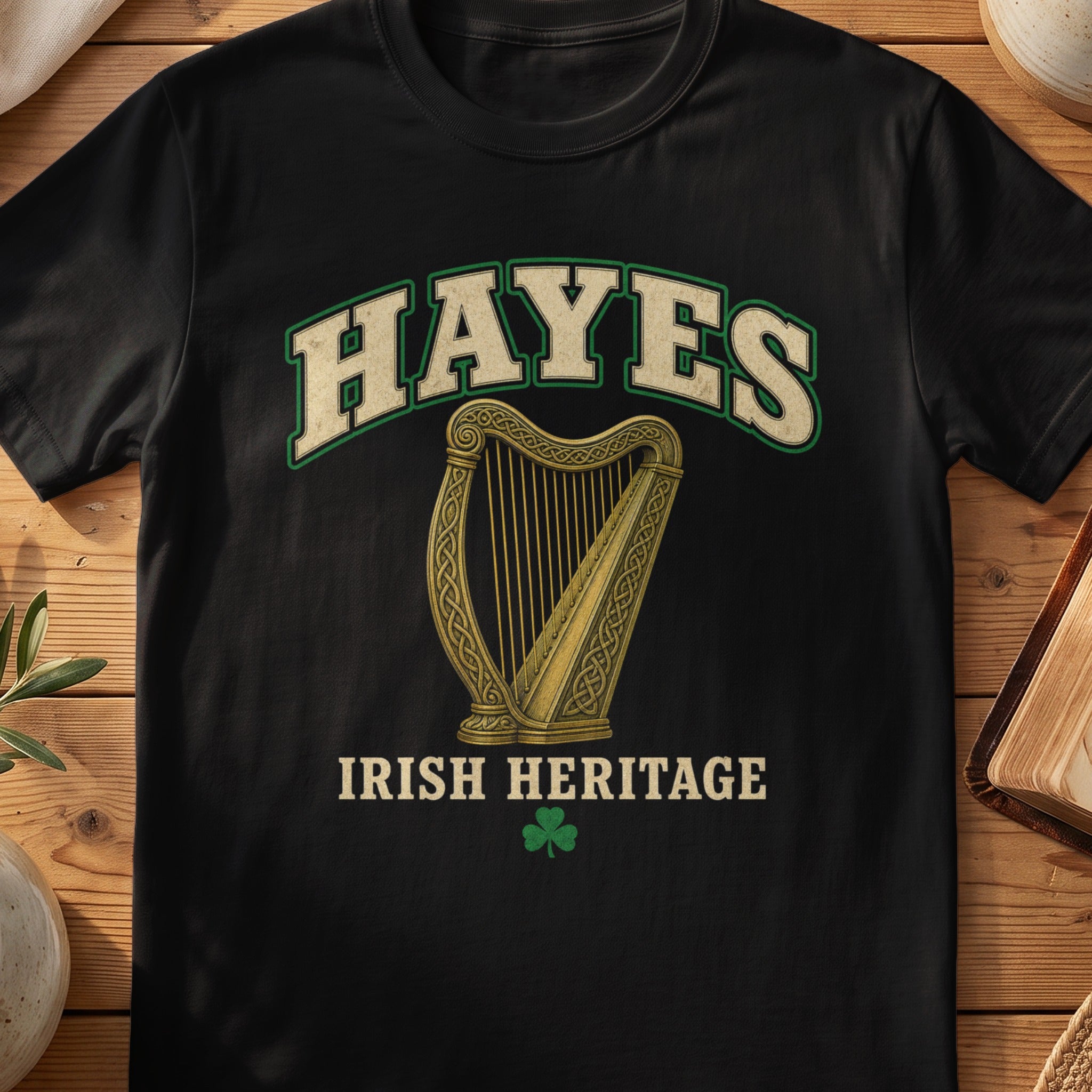 Hayes Irish harp T-shirt in Black, with cream surname lettering, a gold-toned harp, green shamrock and “Irish Heritage” text.