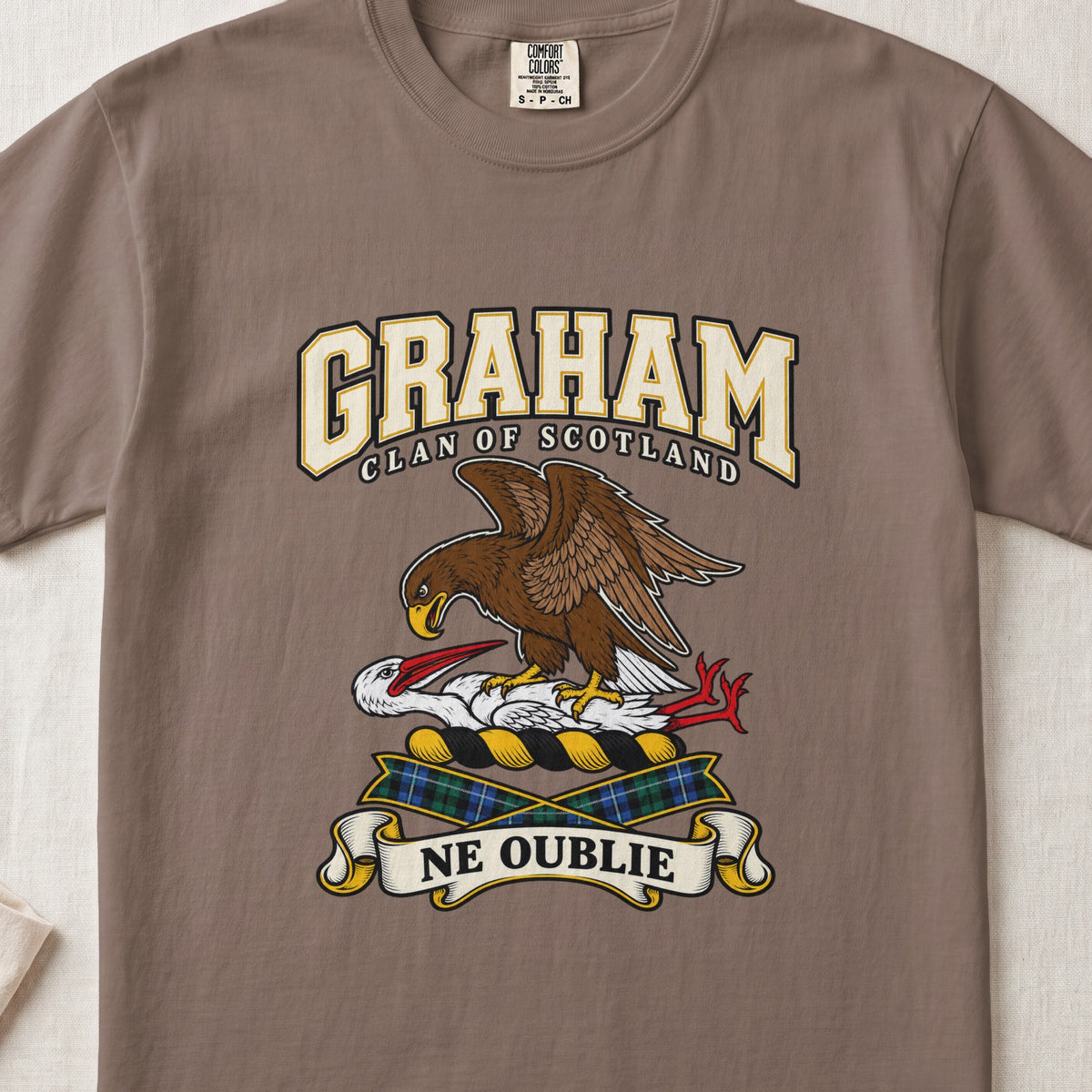 Graham graphic T-shirt in Espresso brown, front flat lay showing varsity lettering and brown eagle-like bird over a white long-necked bird with red beak and legs.