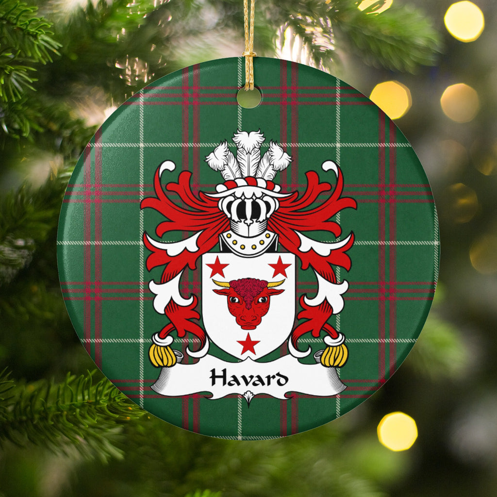 Havard ornament hanging in a Christmas tree with warm lights; a red bull head with gold horns and three red stars on a white shield on Welsh national tartan.