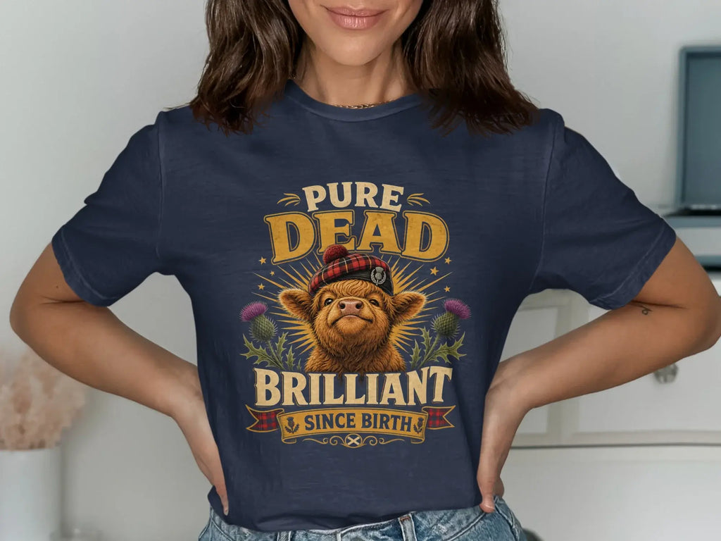 Navy t-shirt with a Scottish Highland cow graphic and "Pure Dead Brilliant" text.