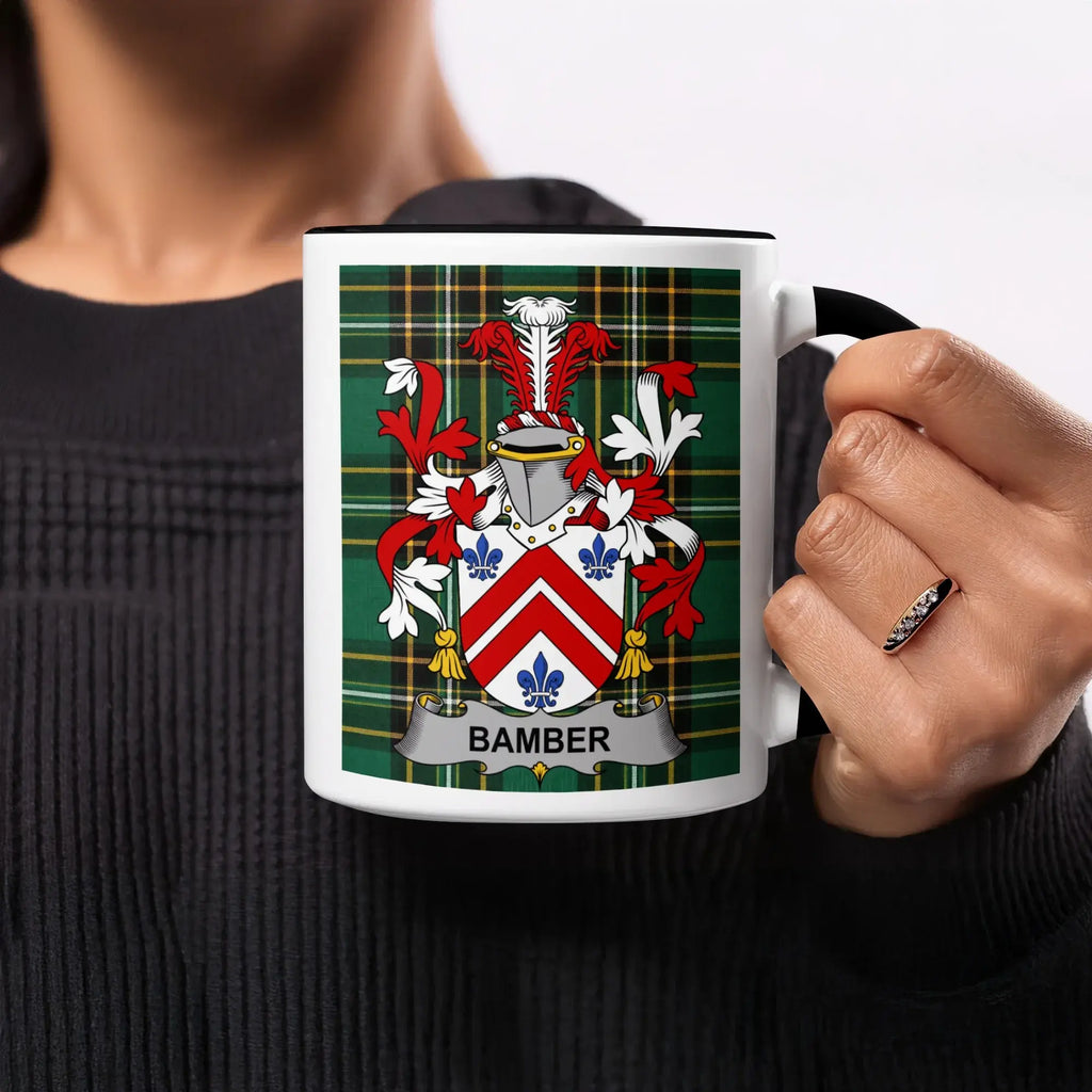 White mug with Bamber family crest on tartan background.