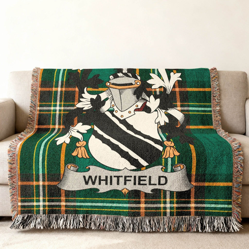 Tartan throw blanket with Whitfield family crest in green and black.