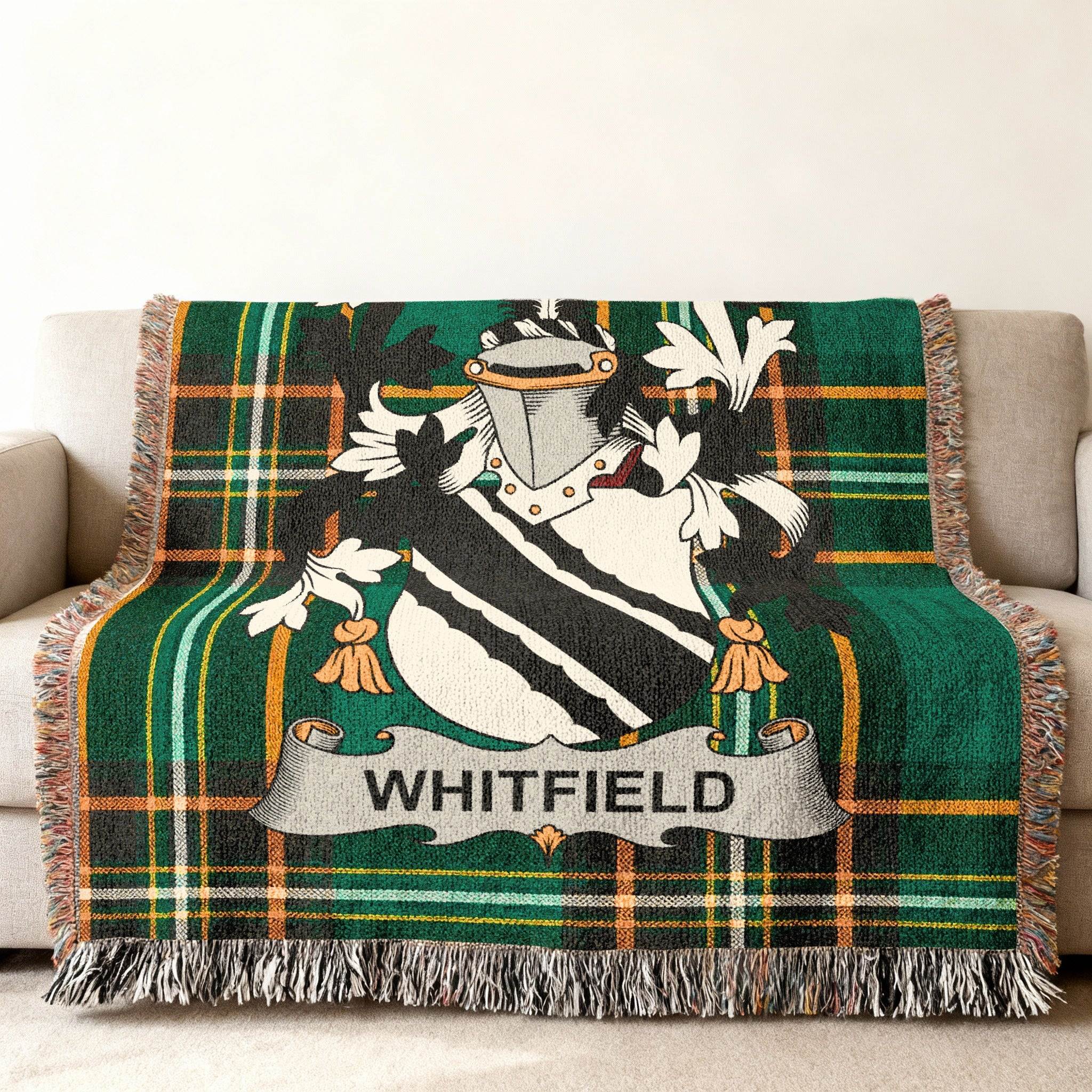 Tartan throw blanket with Whitfield family crest in green and black.