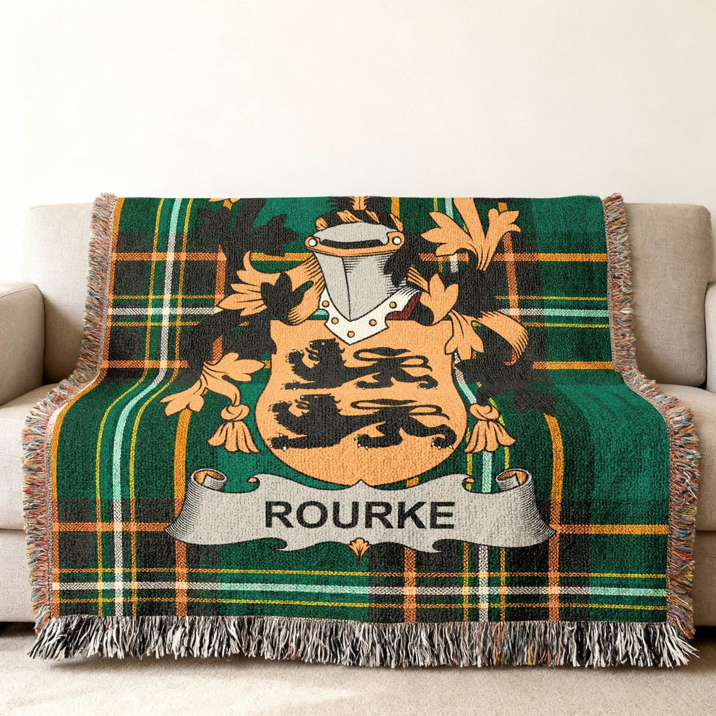 Woven tartan blanket featuring the Rourke family crest in the center.