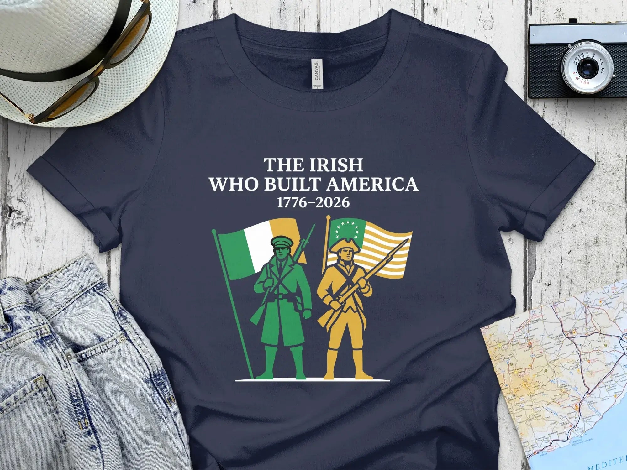 Navy t-shirt with "The Irish Who Built America 1776-2026" and two figures.
