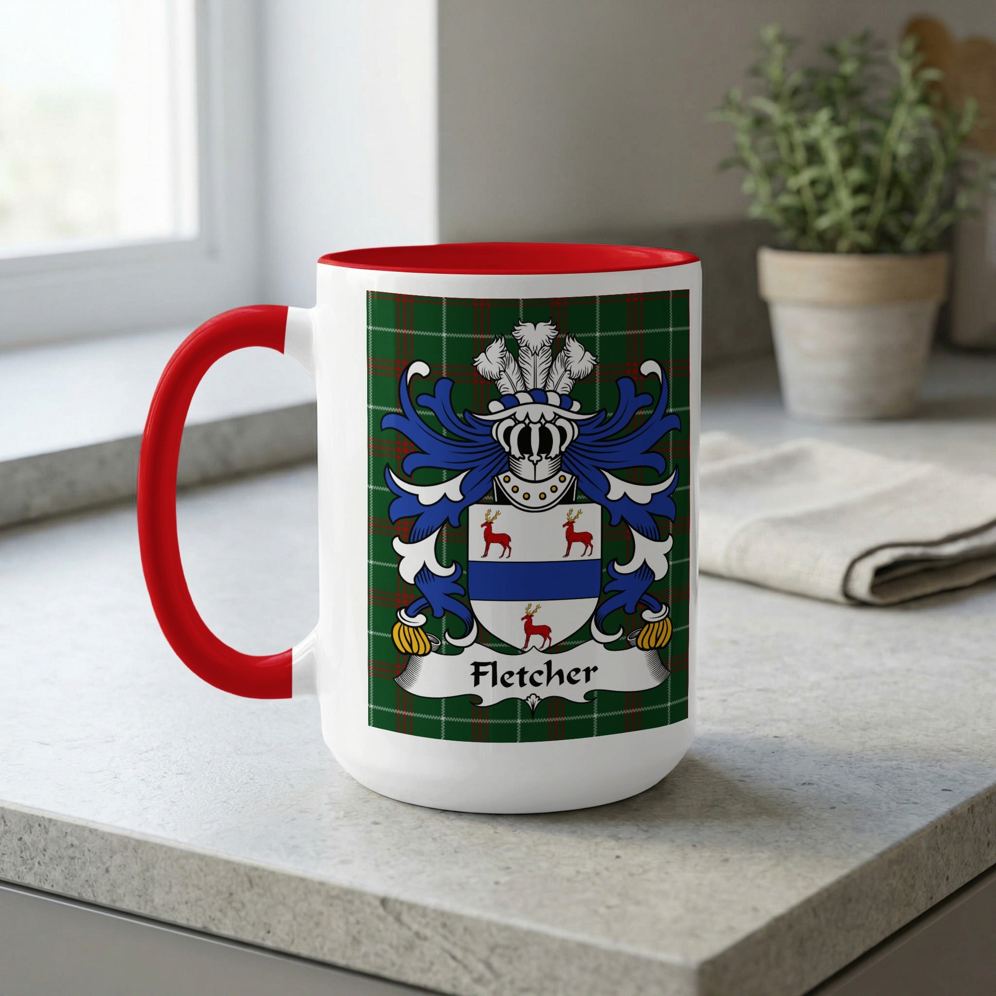 White mug with red handle featuring a tartan pattern and the Fletcher coat of arms.