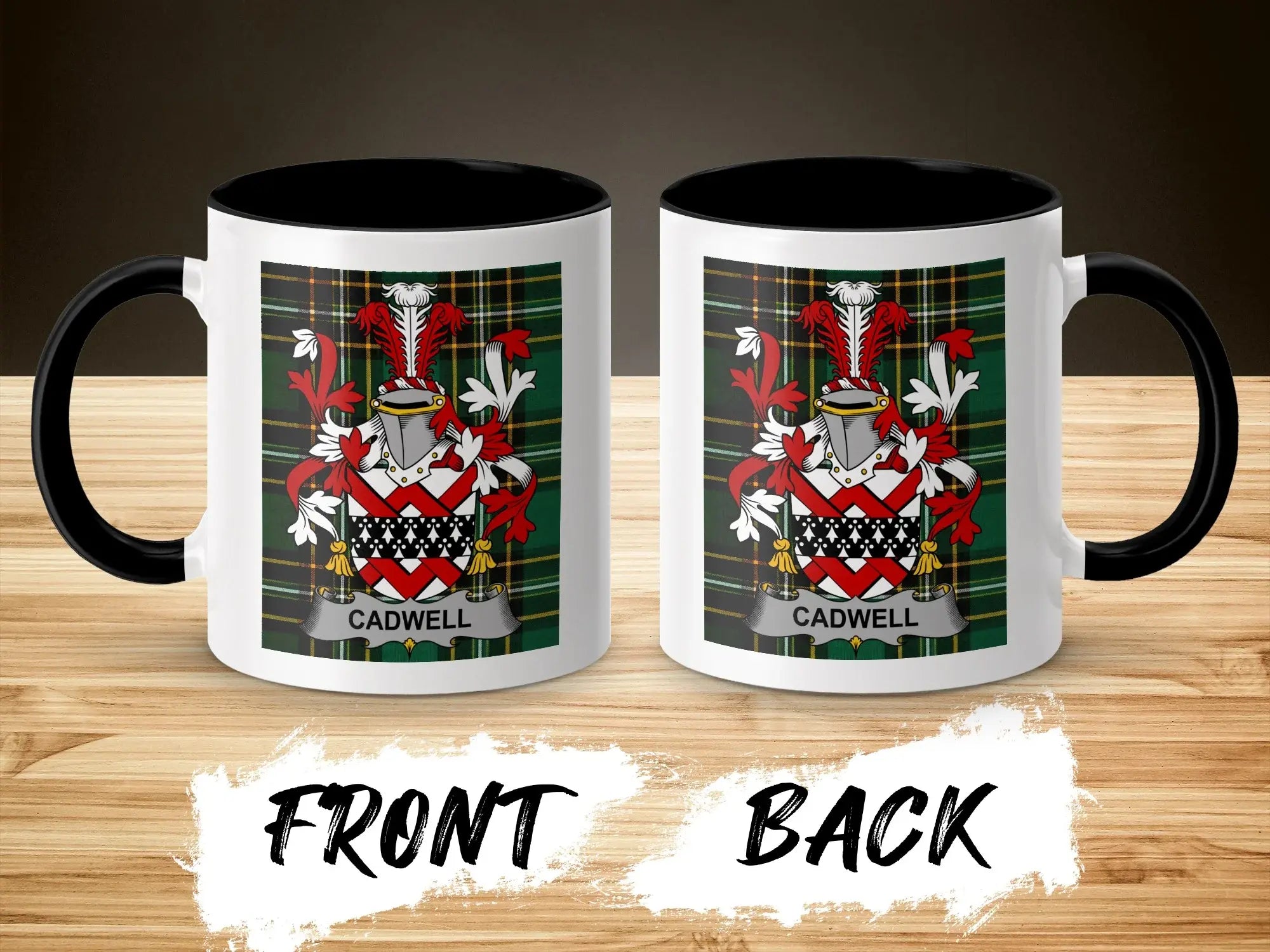 Two mugs with the Cadwell family crest on a wooden surface.