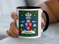 Mug with Herbert family crest on a green tartan background.