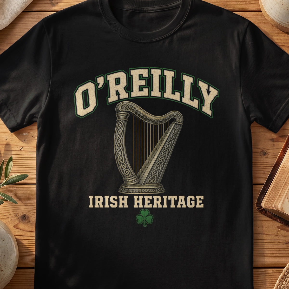 O'Reilly Irish harp T-shirt in Black, with cream surname lettering, a gold-toned harp, green shamrock and “Irish Heritage” text.