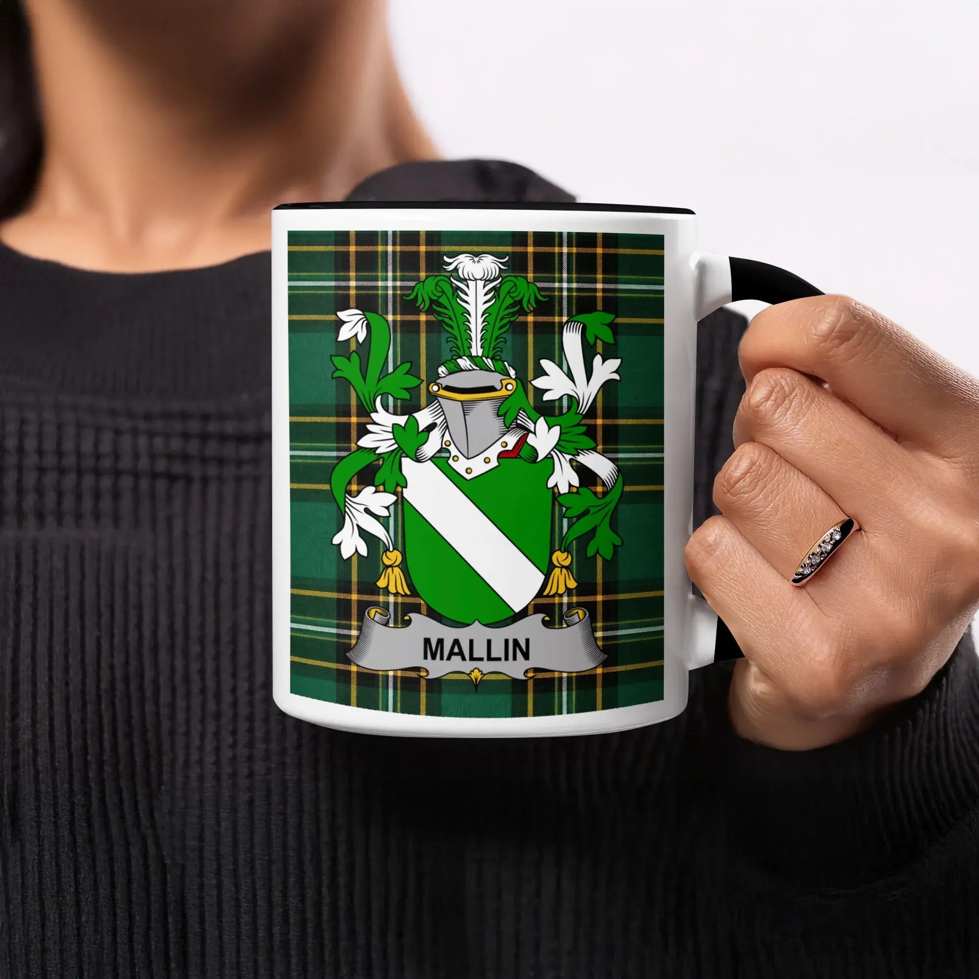Mug with Mallin family crest on a green plaid background.
