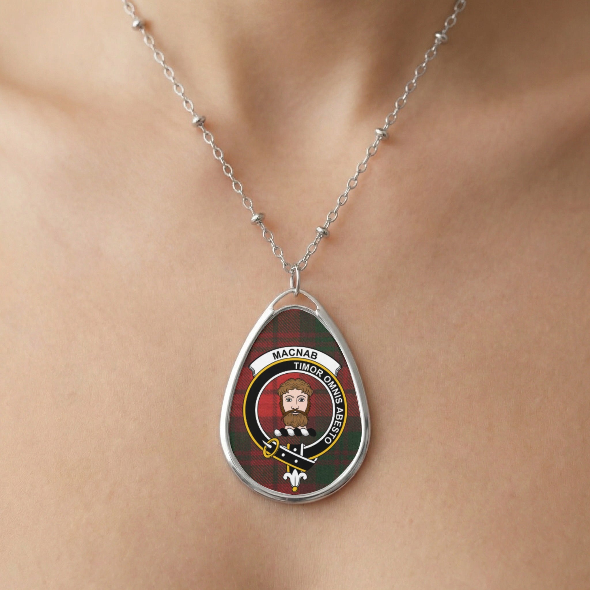 Teardrop pendant on beaded chain, featuring Macnab tartan and crest with Latin motto.