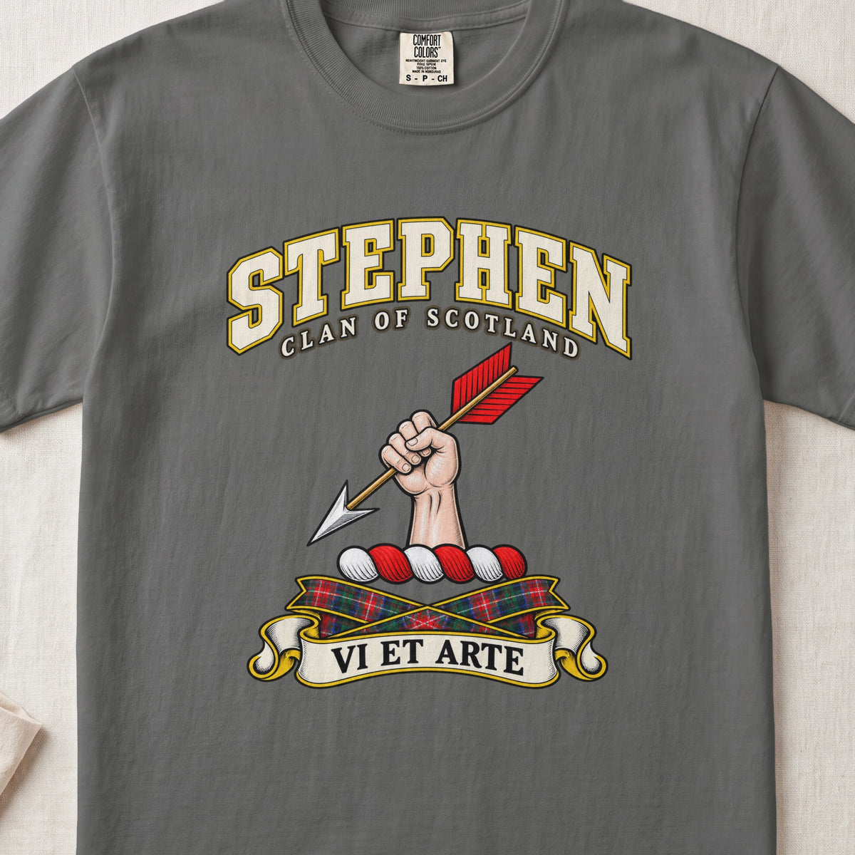 Stephen Scottish clan T-shirt in Pepper, front view with a hand holding an arrow with red feathers and motto design.