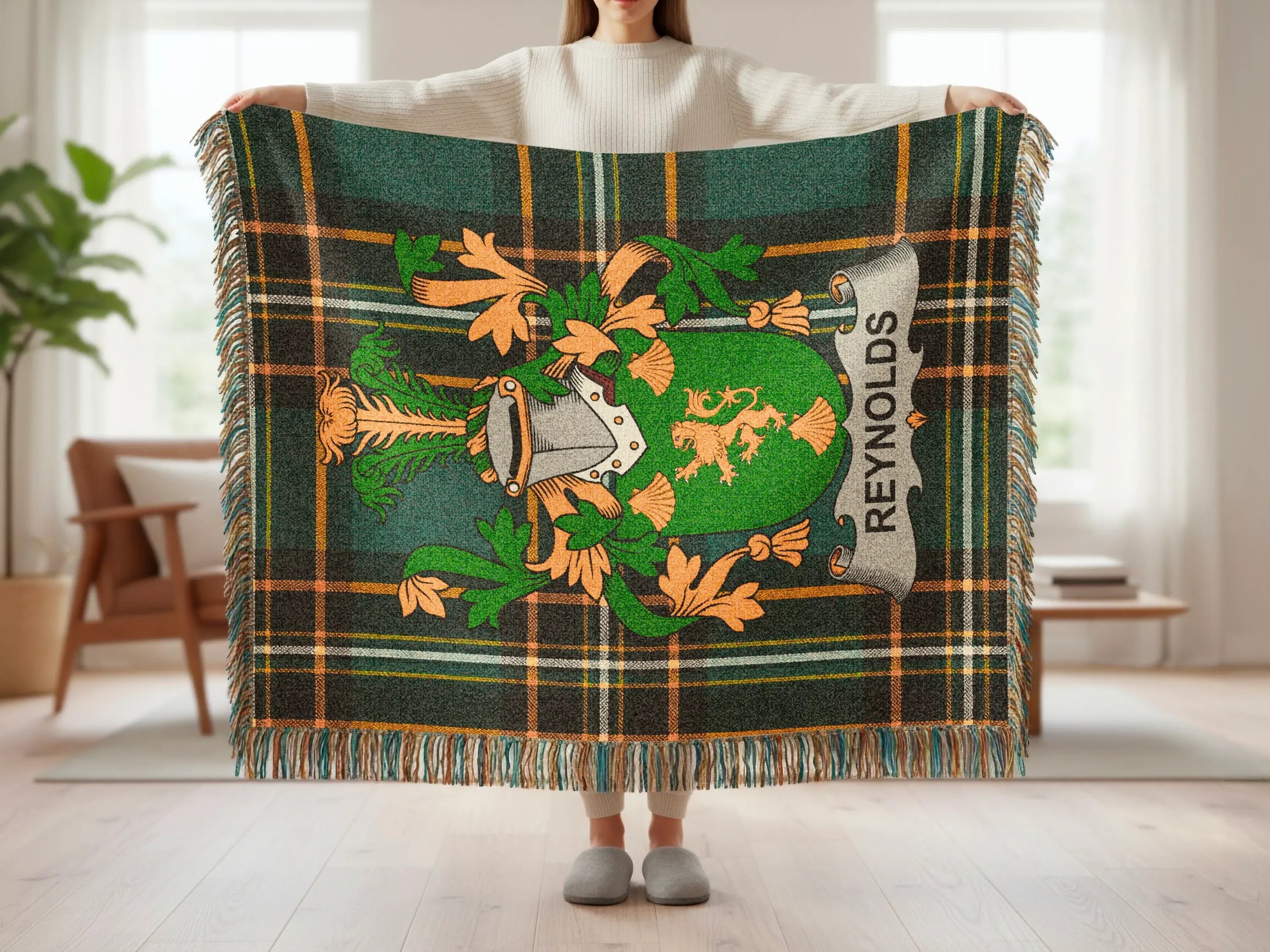 Green tartan blanket with Reynolds family crest displayed.