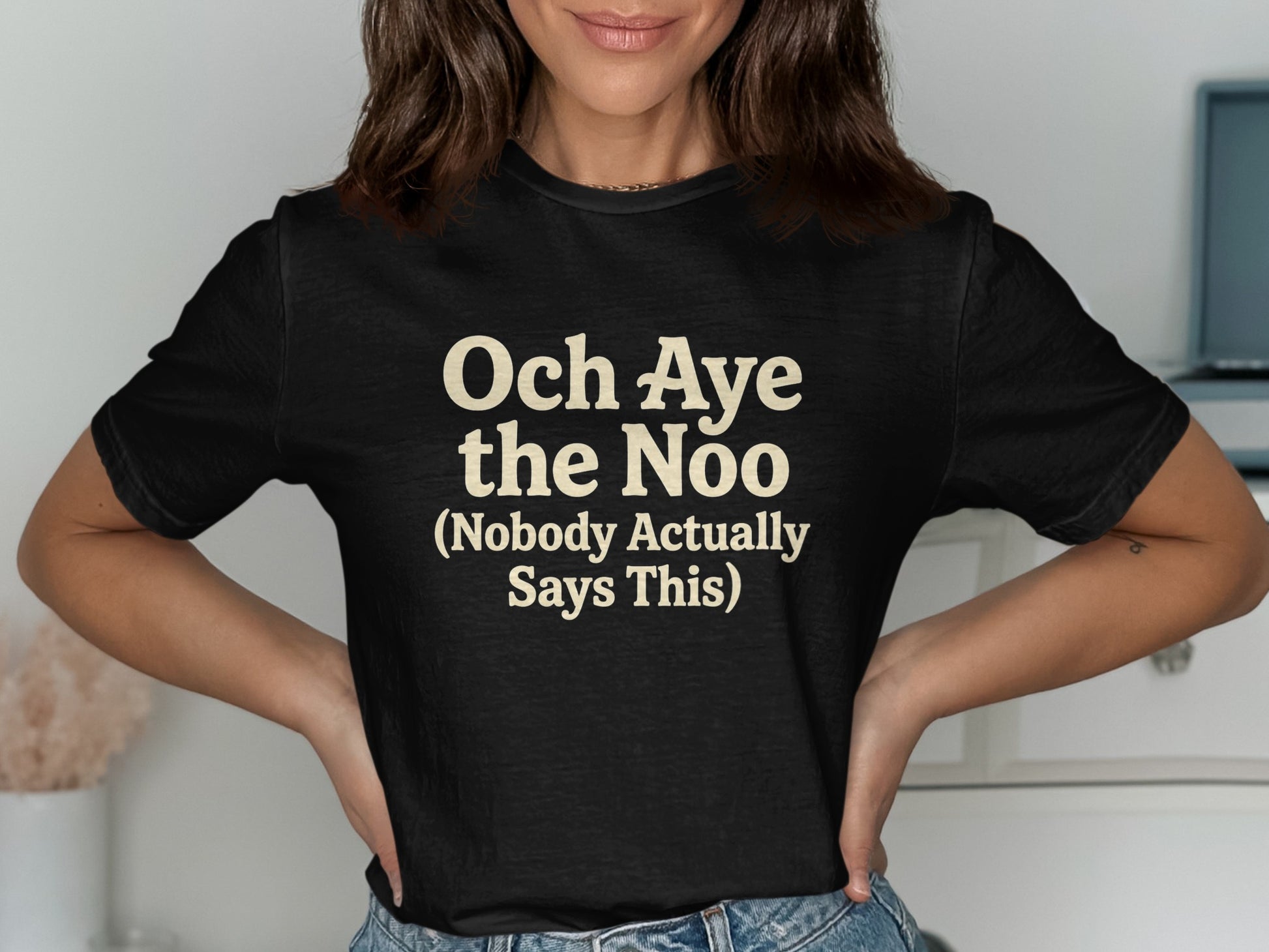 Black t-shirt with "Och Aye the Noo (Nobody Actually Says This)" text in cream.