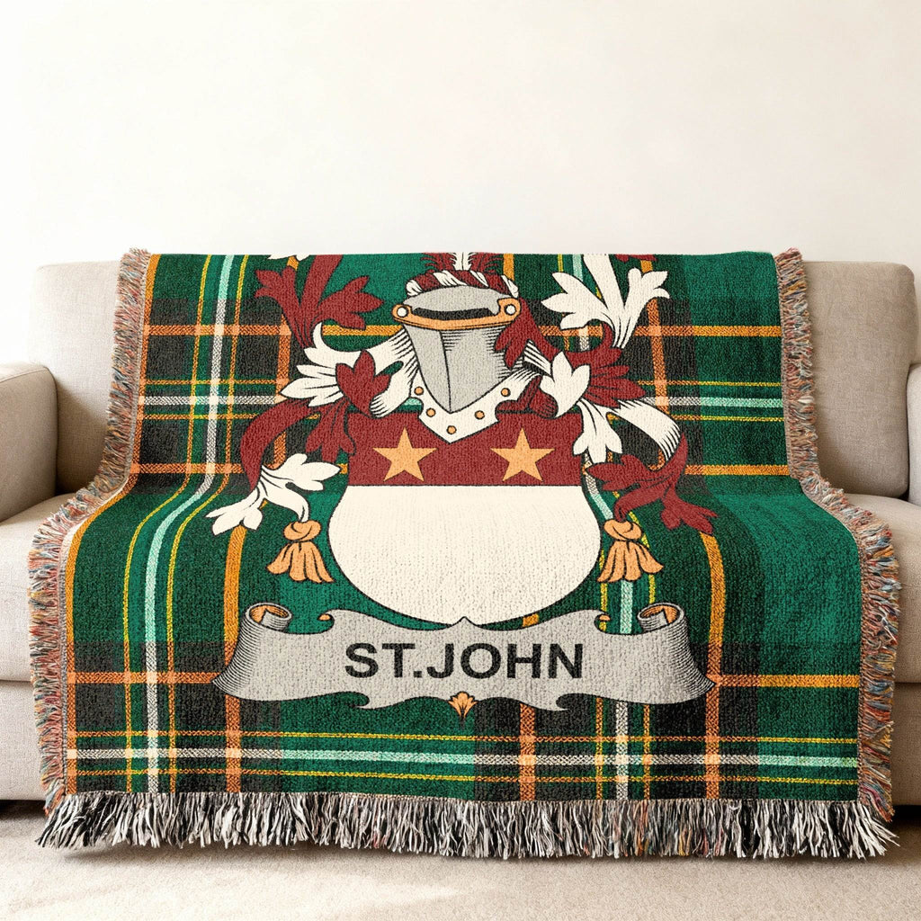 Green plaid throw blanket with St. John crest and fringe.