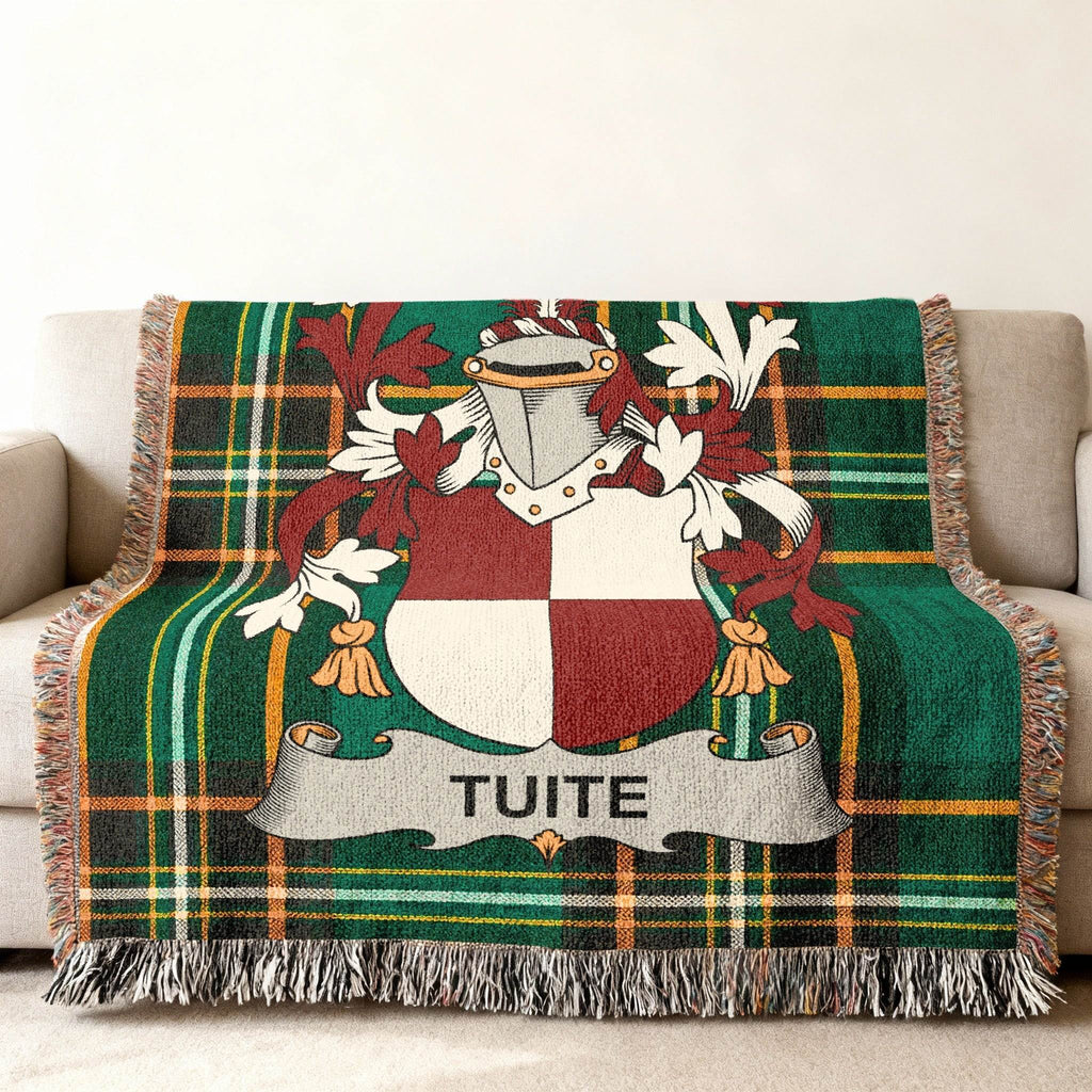 Green plaid throw blanket with TUITE family crest displayed.
