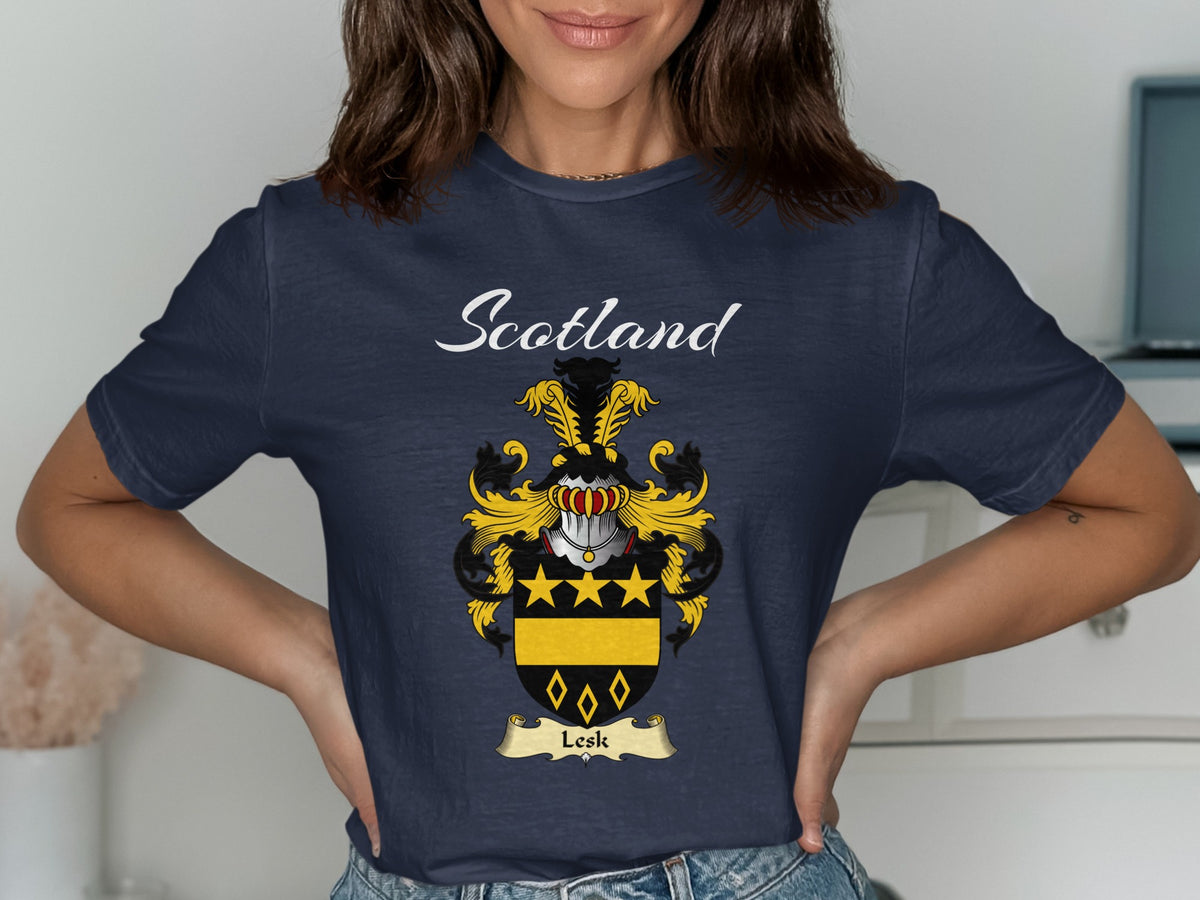 Model wearing a navy Lesk T-shirt featuring gold stars and diamond outlines on black