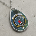 Colquhoun clan Scottish tartan necklace with clan crest and Si Je Puis motto on tartan background