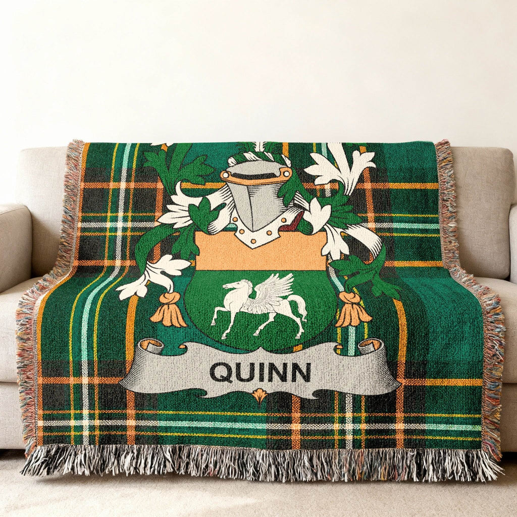 Green plaid throw blanket with QUINN crest featuring a pegasus.