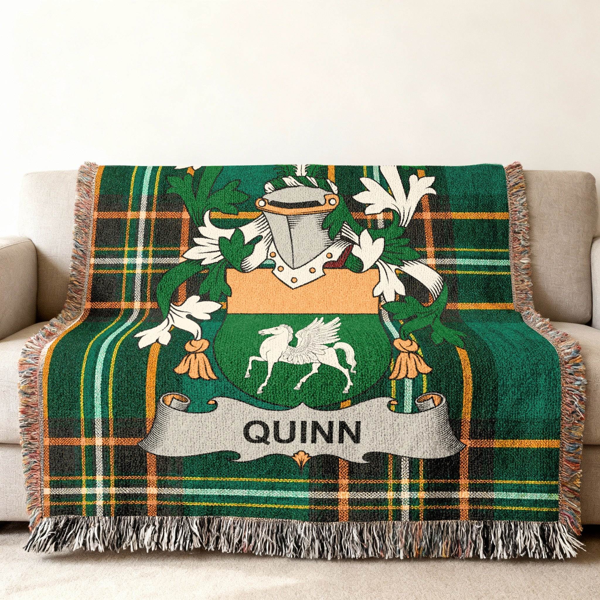 Green plaid throw blanket with QUINN crest featuring a pegasus.