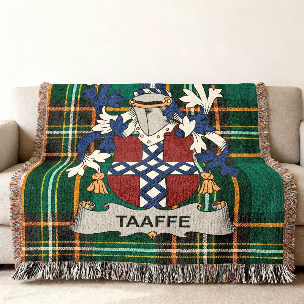Taafe family crest on a green plaid woven throw blanket.