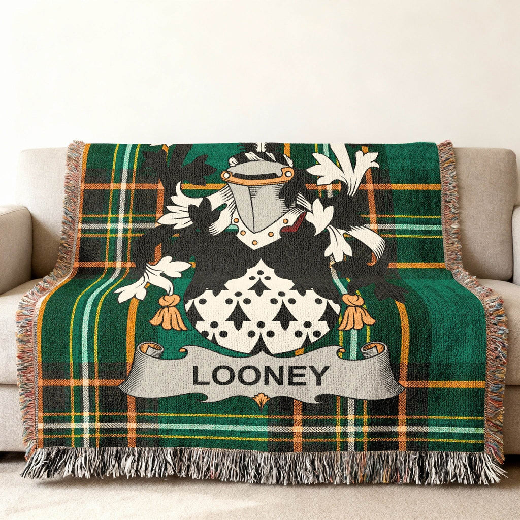 Green plaid throw blanket featuring a coat of arms with the name "LOONEY."