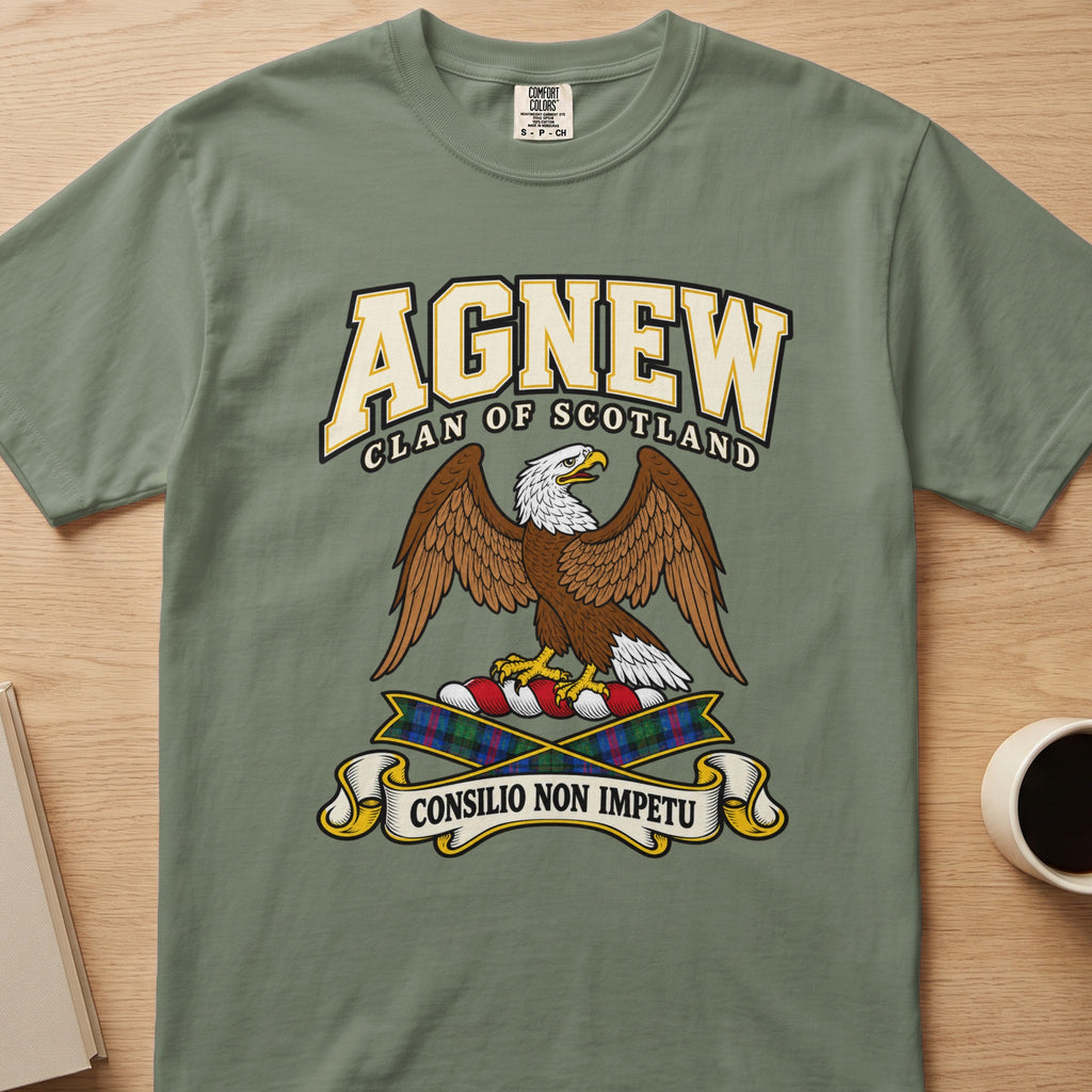 Agnew brown spread-wing bird crest graphic on a sage green Comfort Colors T-shirt, front view