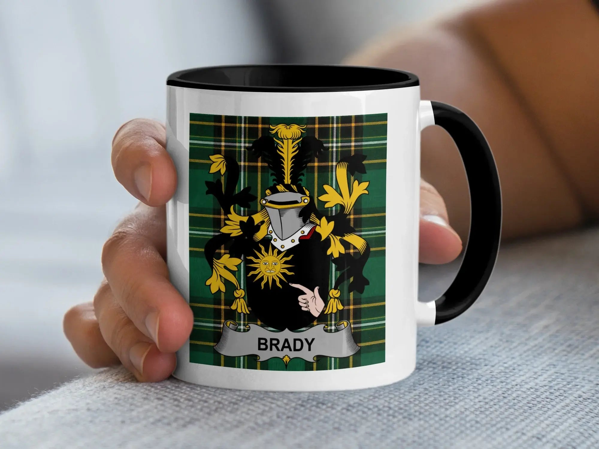 White mug with black rim featuring a coat of arms with the name BRADY.