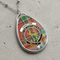 Chattan clan Scottish tartan necklace with clan crest and motto on tartan background
