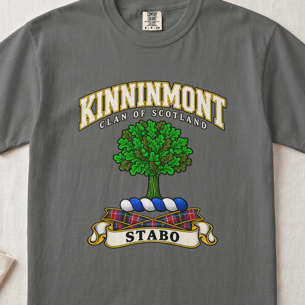 Kinninmont Scottish clan T-shirt in Pepper, front view with a green tree and motto banner.
