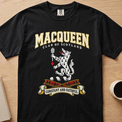 MacQueen white spotted animal crest graphic on a black Comfort Colors T-shirt, front view