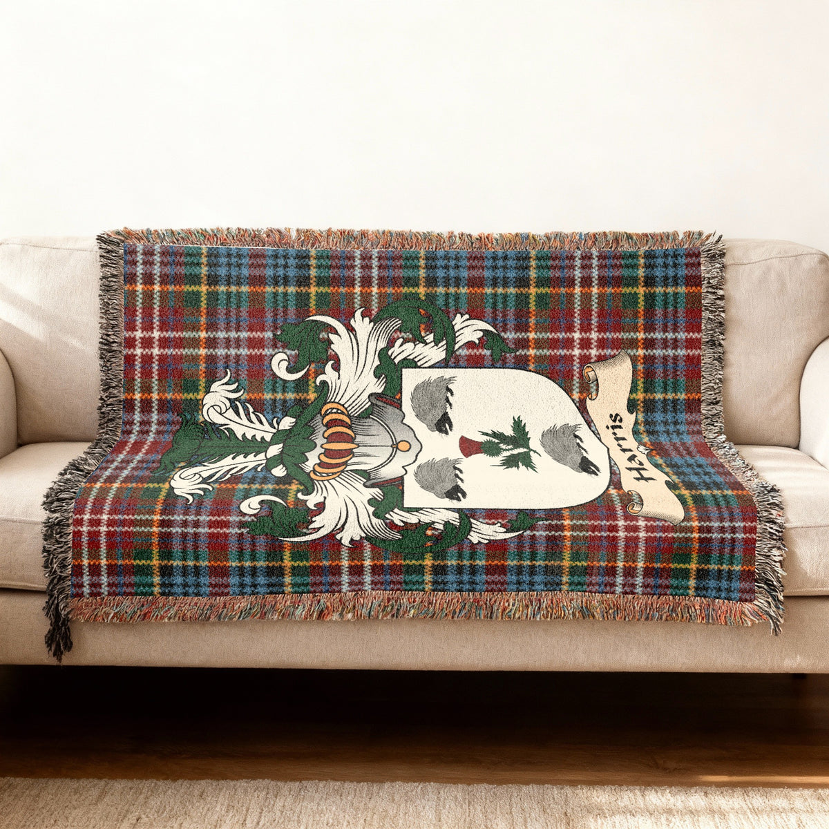 Harris Scottish woven blanket with family shield and Caledonia tartan background