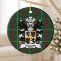 Macsen ornament hanging from a pale wooden branch, showing a quartered white-and-gold shield with black lions and eagles on Welsh National Tartan.