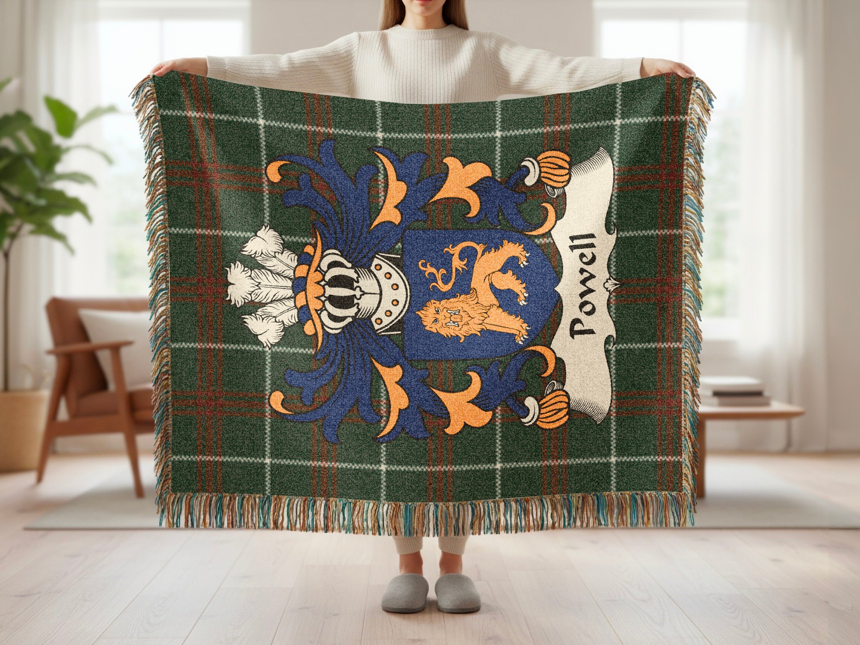 Powell family crest displayed on a plaid blanket with fringe.