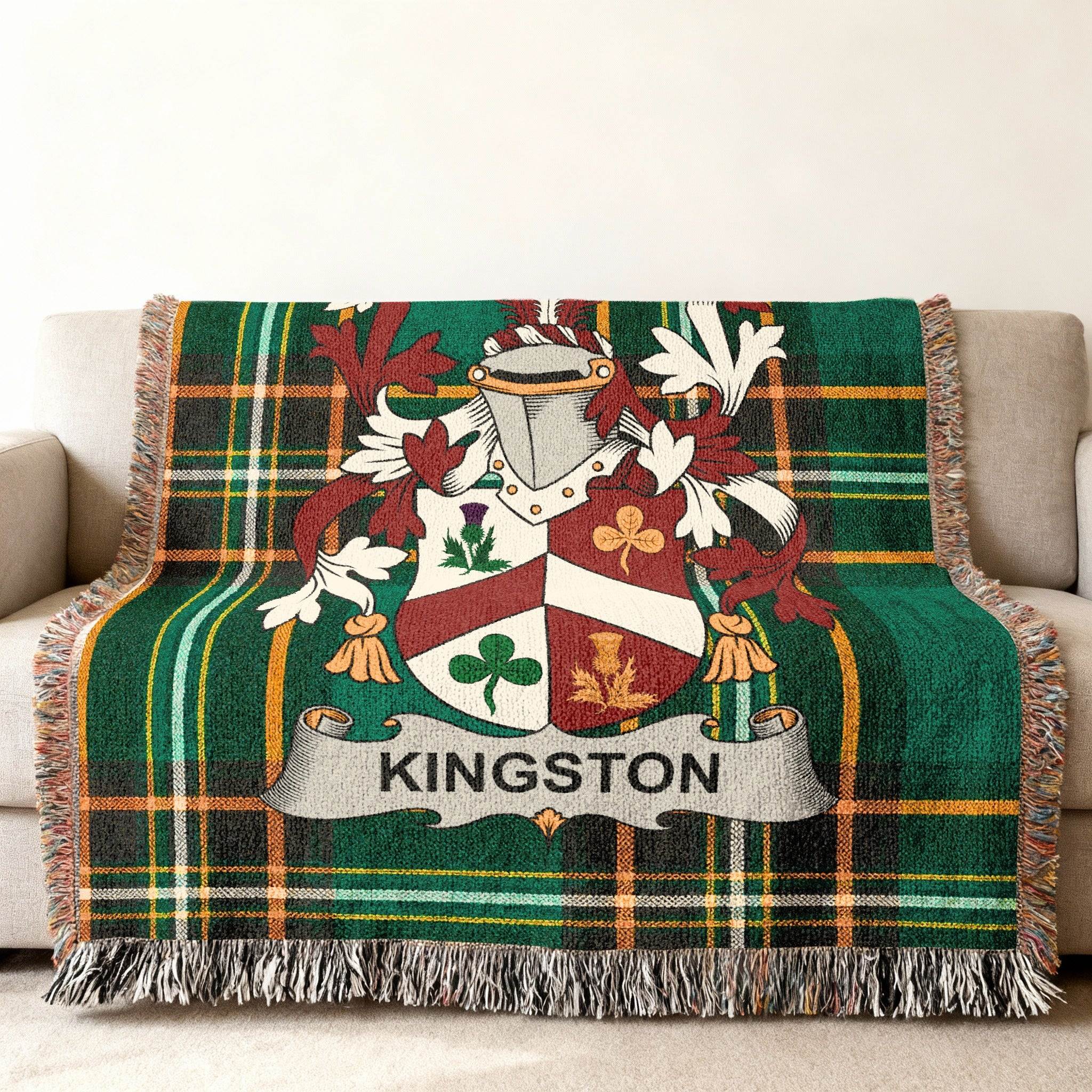 Kingston crest on a green plaid woven throw blanket with fringe.
