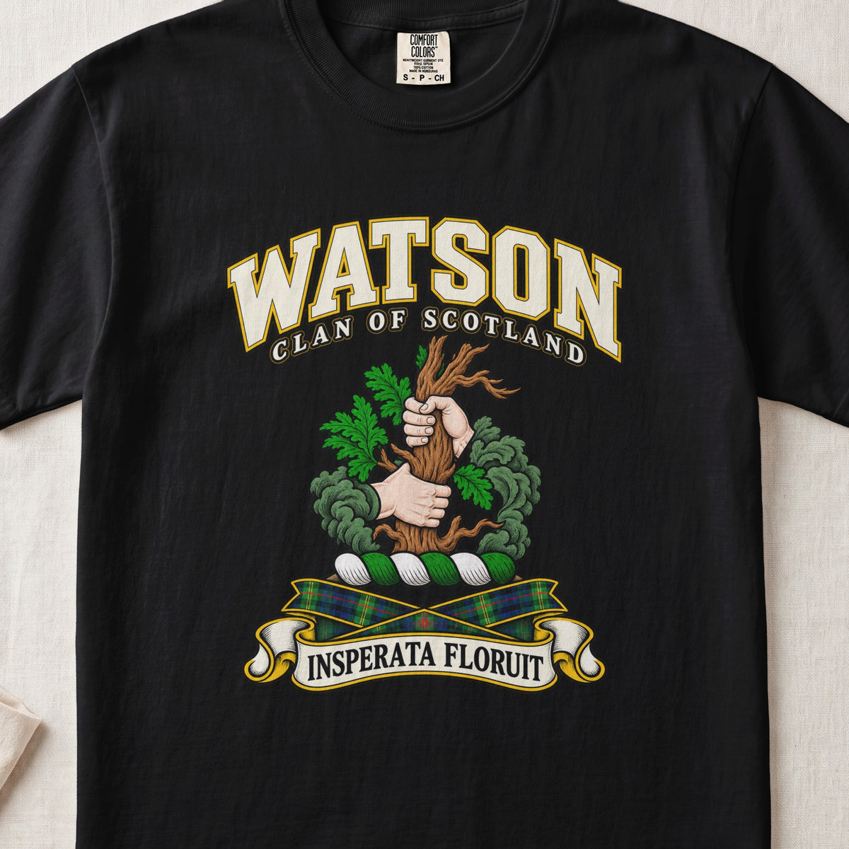 Watson Scottish clan T-shirt in Black, front view with two hands gripping a tree trunk with green foliage and motto banner.