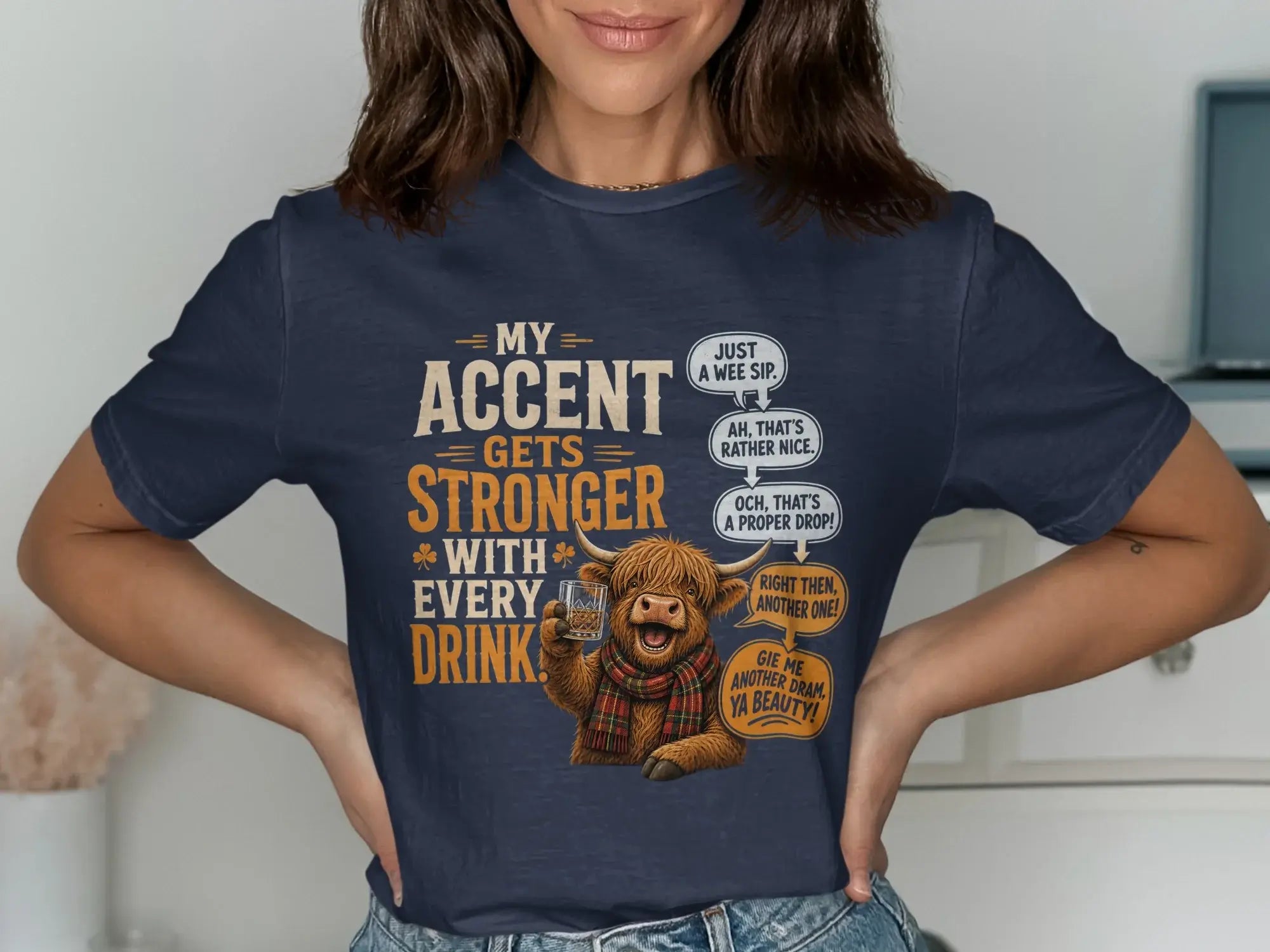 T-shirt with Highland cow graphic and Scottish slang phrases about drinking.
