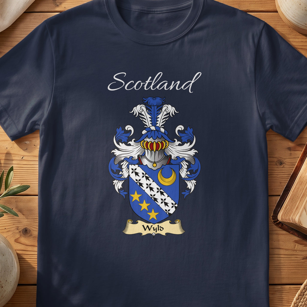 Navy Wyld heritage T-shirt laid flat with “Scotland” and the colourful family shield design.
