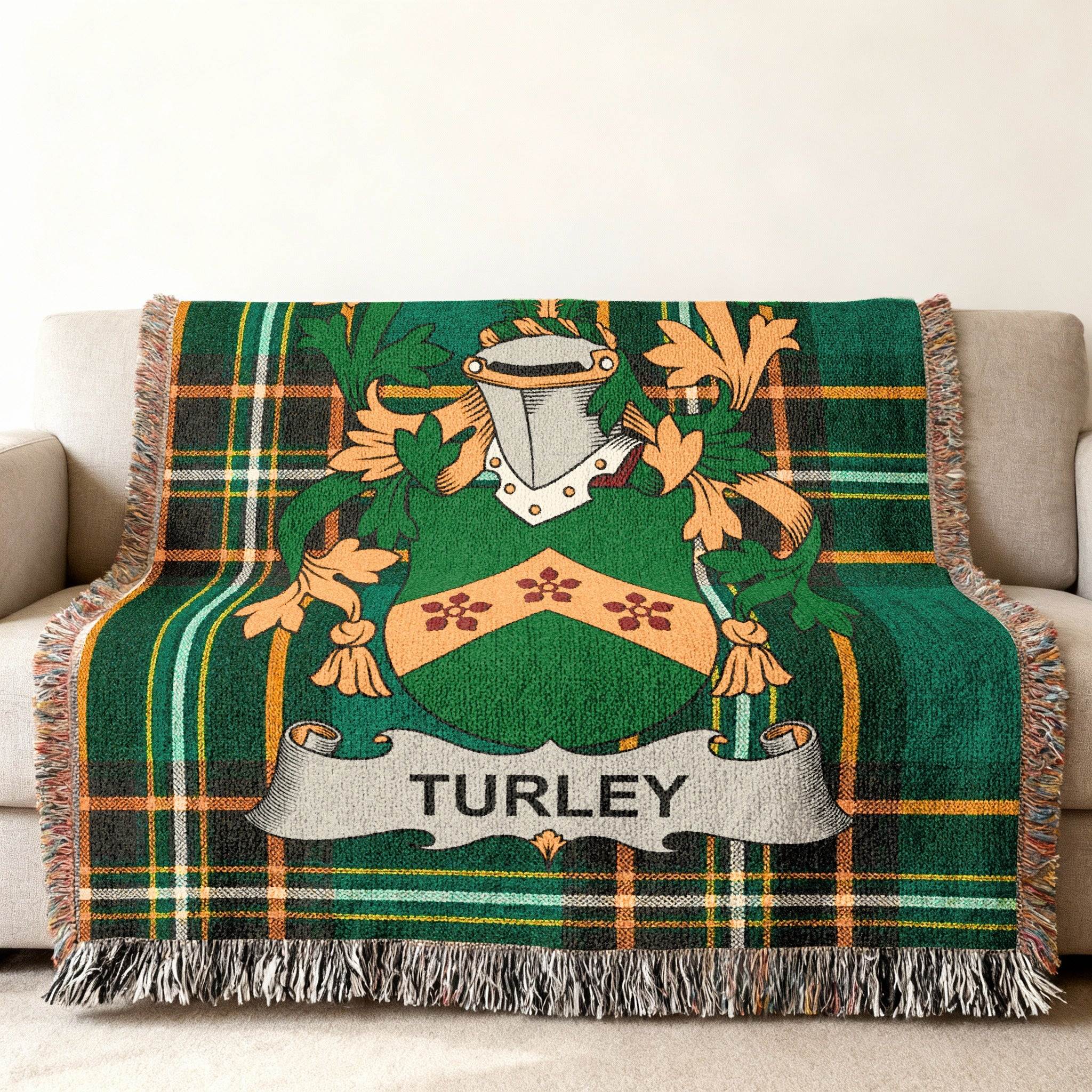 Woven throw blanket with green tartan pattern and the Turley family crest.