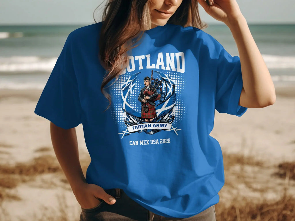 Blue t-shirt with "Scotland Tartan Army Can Mex USA 2026" text and bagpiper illustration.