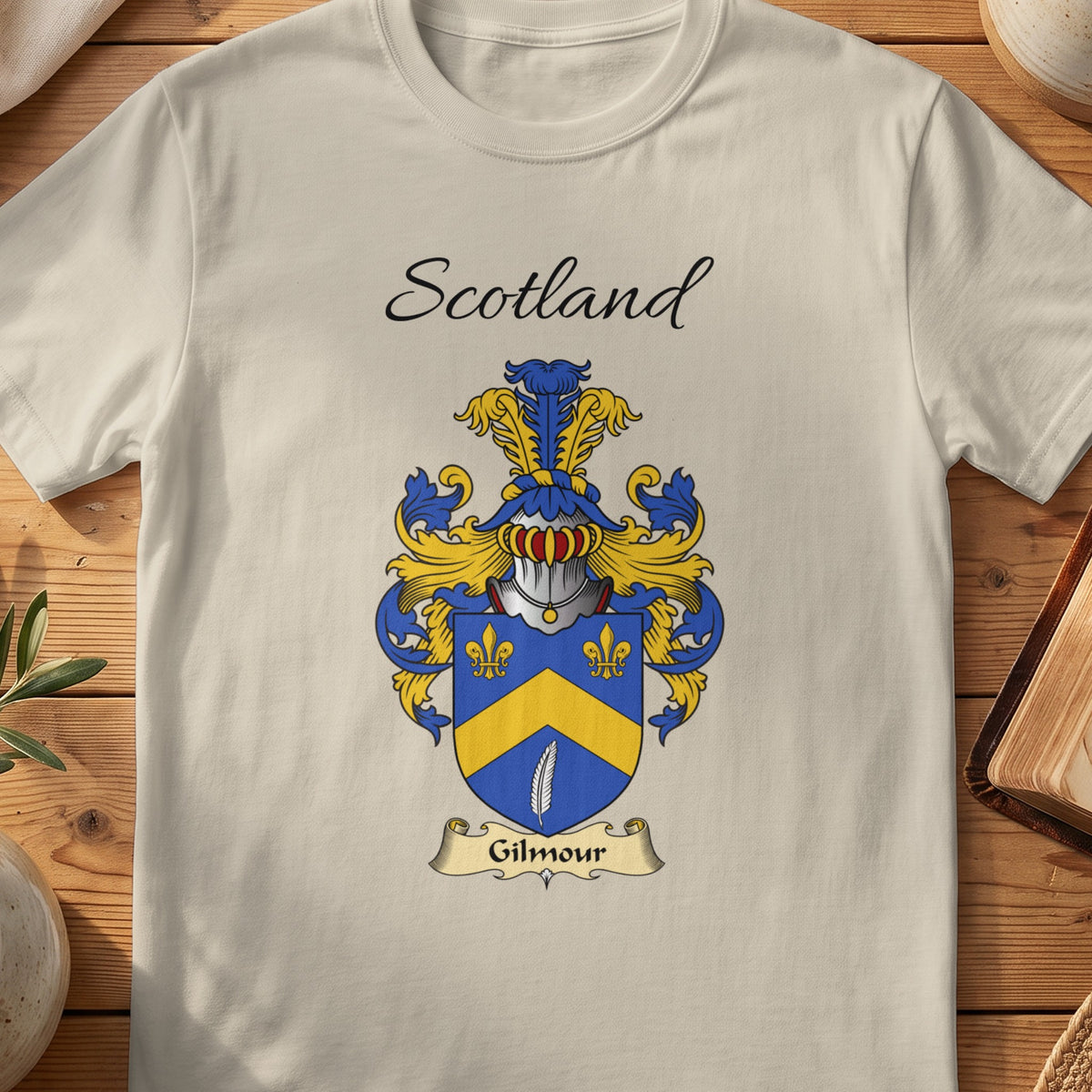 Sand Gilmour Scottish family shield T-shirt featuring a gold chevron and fleurs-de-lis on blue