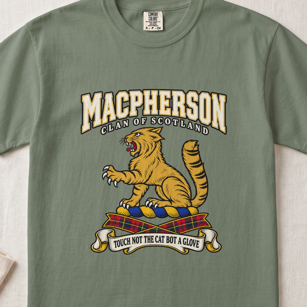 MacPherson graphic T-shirt in Moss green, front flat lay showing varsity lettering and seated gold wildcat with black stripes, raised paw and upright tail.