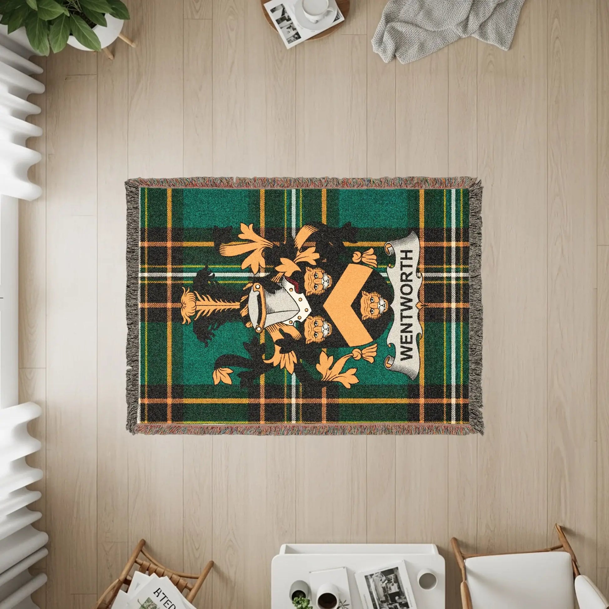 Woven throw blanket featuring a green and black tartan with a lion crest and "WENTWORTH" text.