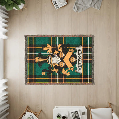 Woven throw blanket featuring a green and black tartan with a lion crest and "WENTWORTH" text.