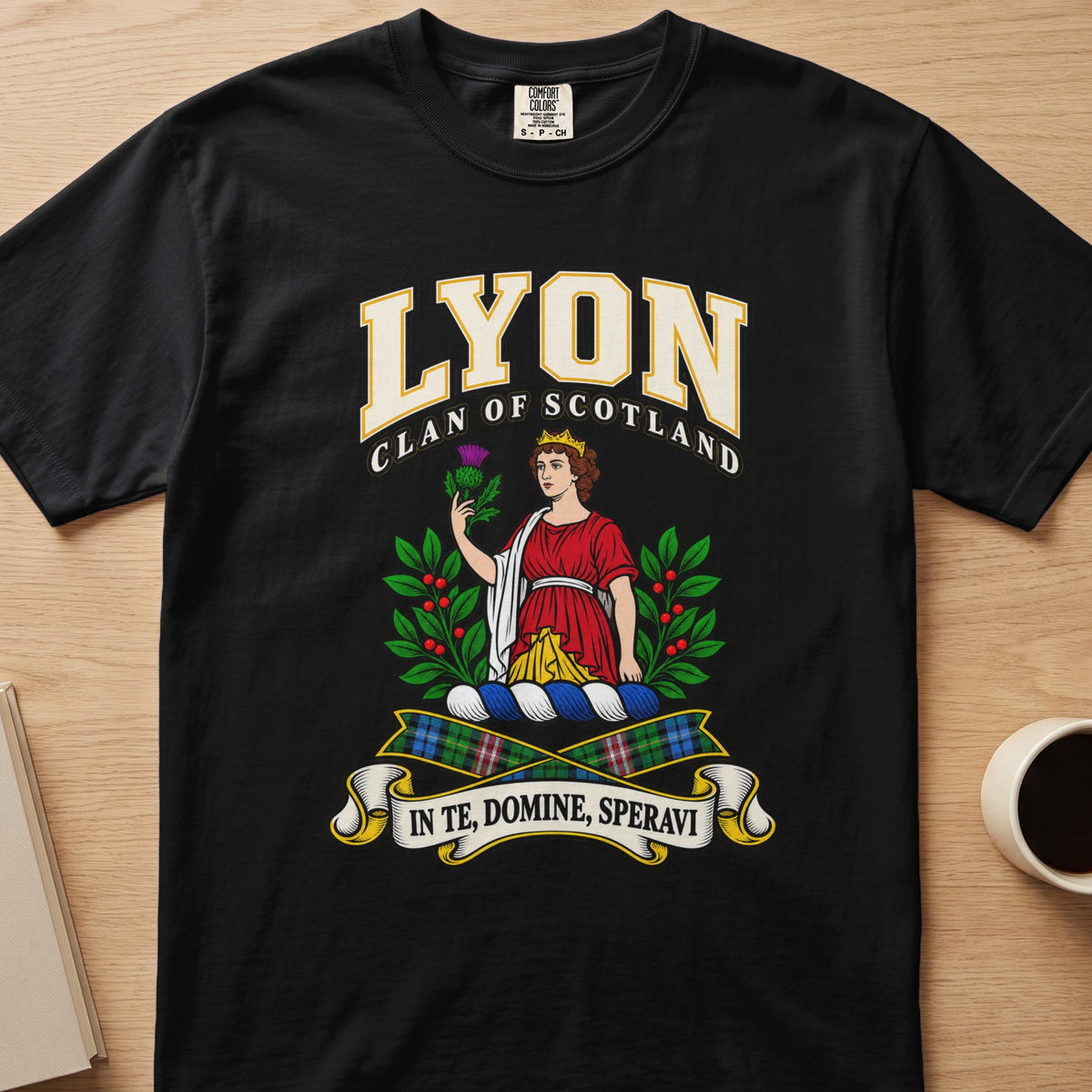 Lyon red-clad figure framed by green branches graphic on a black Comfort Colors T-shirt, front view