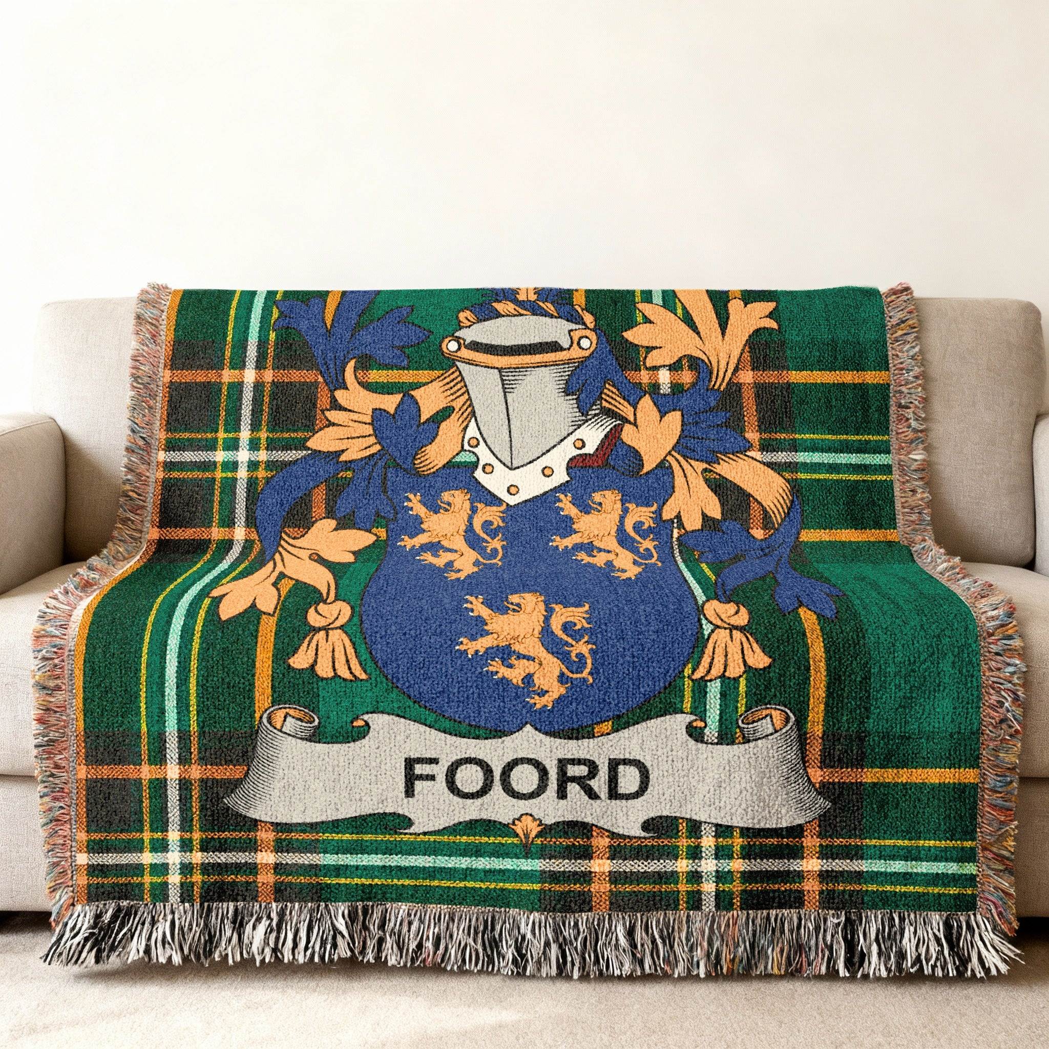 Green plaid throw blanket with a Foord family crest featuring lions.