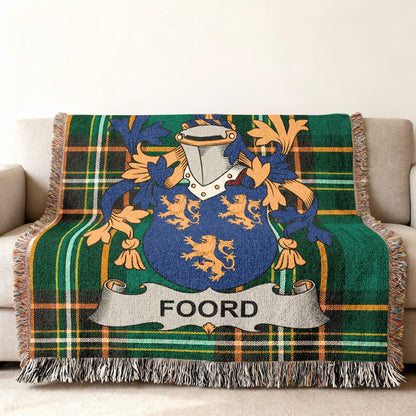 Green plaid throw blanket with a Foord family crest featuring lions.